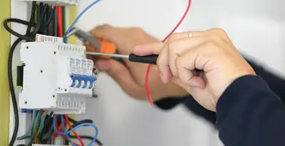 Electrician installing and adjusting circuit breakers in an electrical panel in Columbia, SC