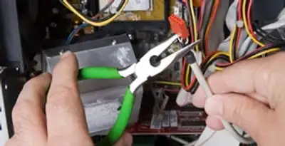 Licensed electrical contractor performing electrical repair with tools in Elgin, SC