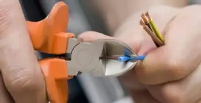 professional electrical services showing precise wire cutting by licensed electricians in Columbia, SC