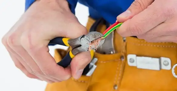 licensed electrician securing electrical wiring with professional tools during service work in Columbia, SC