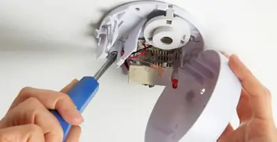 Certified technician wiring smoke detector during installation in Columbia, SC